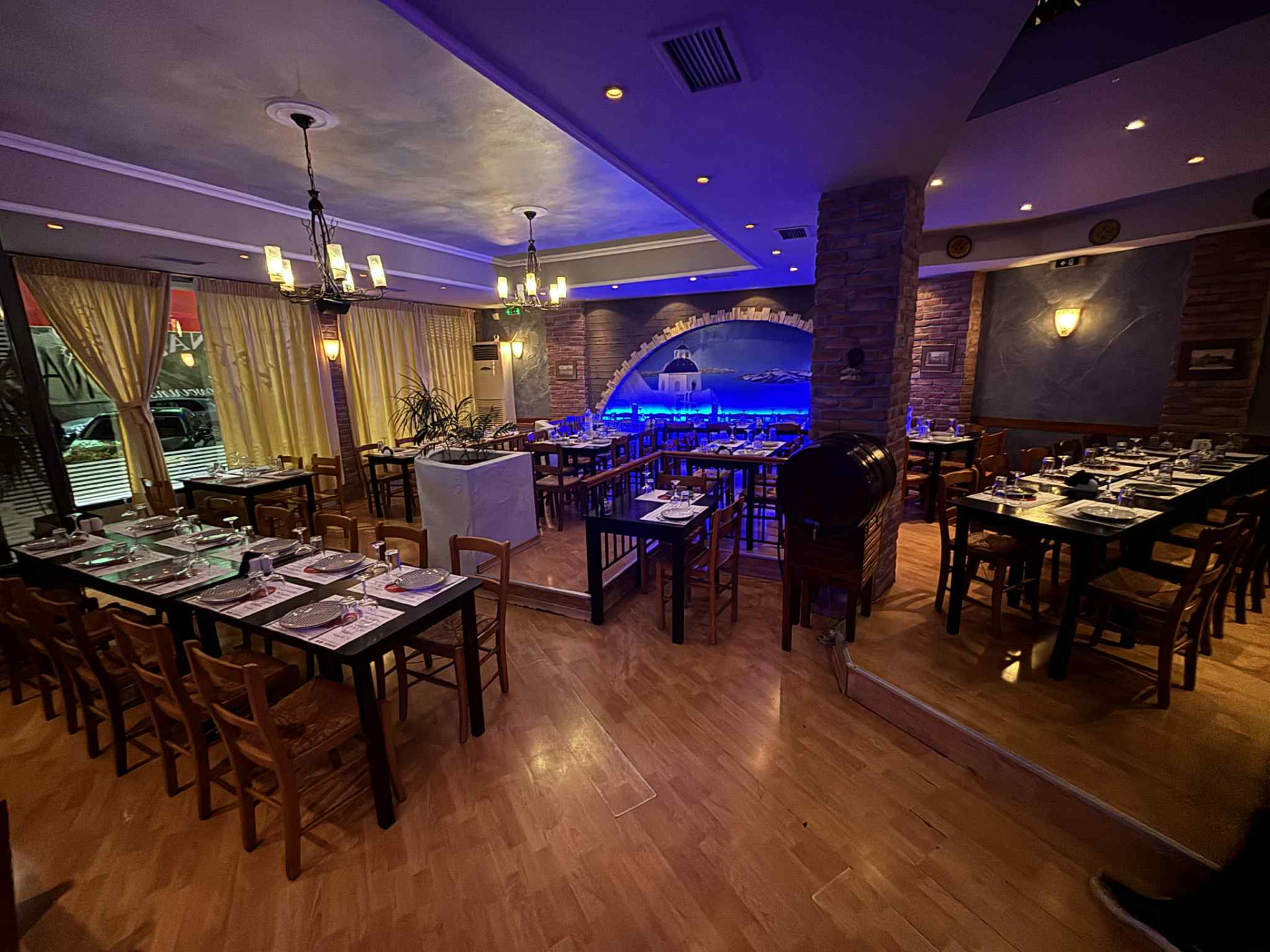 The main dining room at Karnagio today, with brick columns and the painted Santorini arch