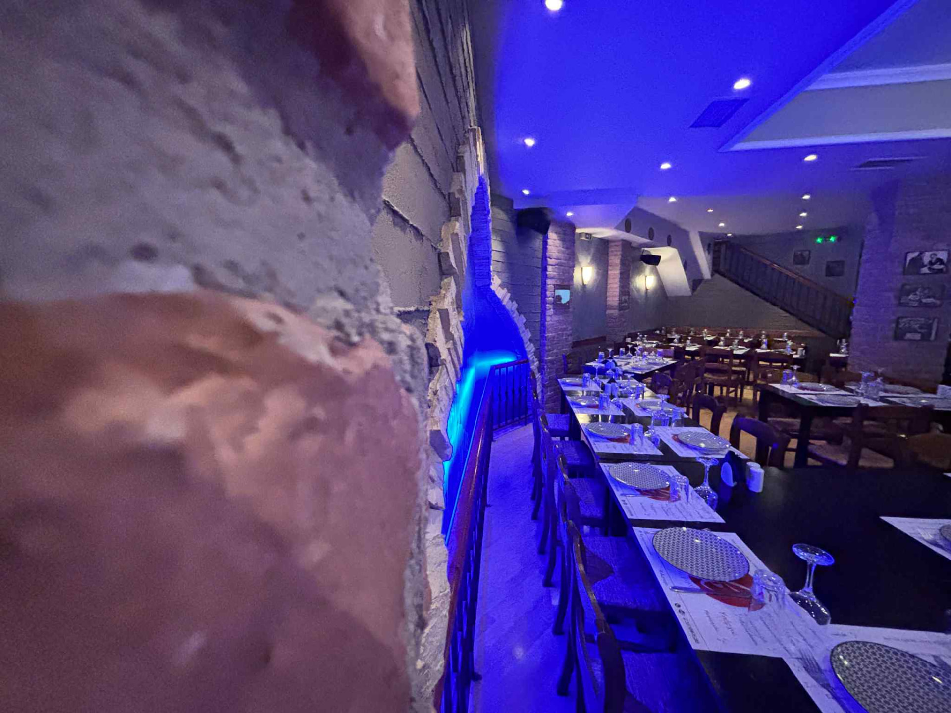 The Karnagio dining room in blue light, with stone masonry in the foreground